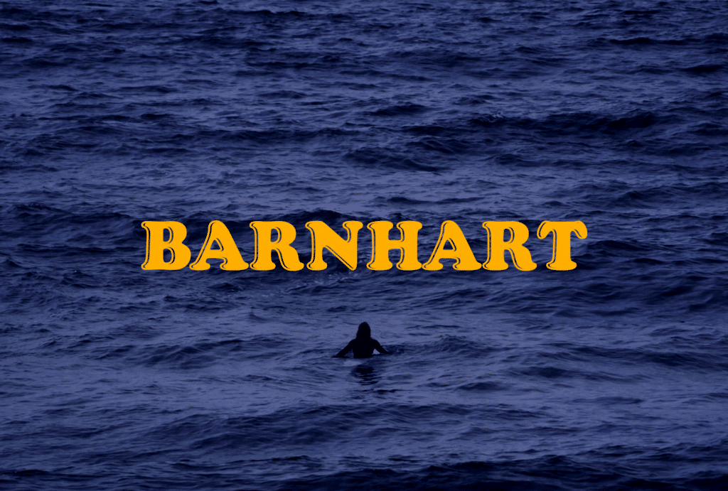 a man sitting on a surfboard in the ocean on his own at night